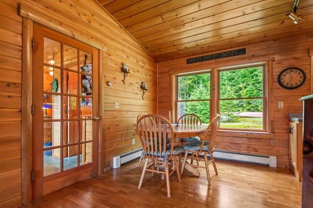 62 Antler Way, Rangeley, ME 04970 - dining area with vaulted ceiling, a baseboard radiator, wood finished floors, wood ceiling, and wooden walls
