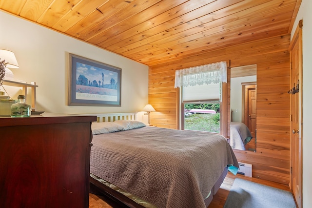 62 Antler Way, Rangeley, ME 04970 - bedroom featuring wood walls, baseboard heating, wooden ceiling, and wood finished floors