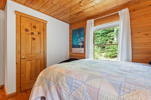 62 Antler Way, Rangeley, ME 04970 - bedroom with wood ceiling and wood finished floors