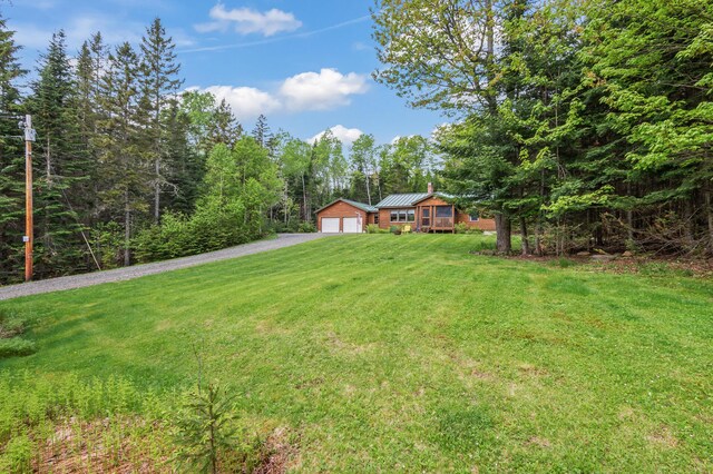 62 Antler Way, Rangeley, ME 04970 - view of grassy yard featuring asphalt driveway and an outdoor structure
