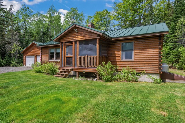 62 Antler Way, Rangeley, ME 04970 - log home with a standing seam roof, a chimney, a front yard, metal roof, and a garage