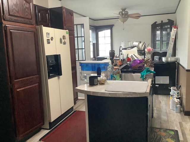 kitchen featuring light hardwood / wood-style floors, white refrigerator with ice dispenser, and ceiling fan