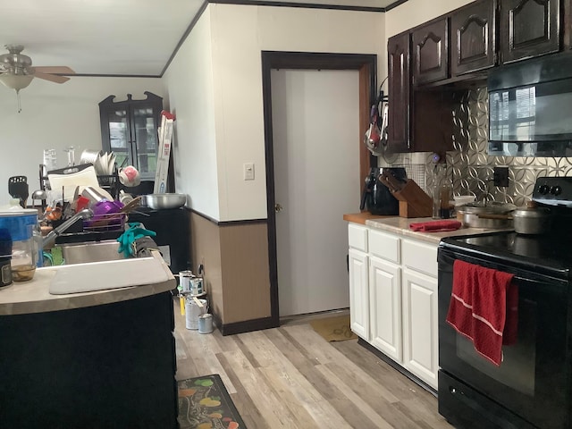 kitchen with ceiling fan, white cabinetry, black appliances, crown molding, and light hardwood / wood-style floors