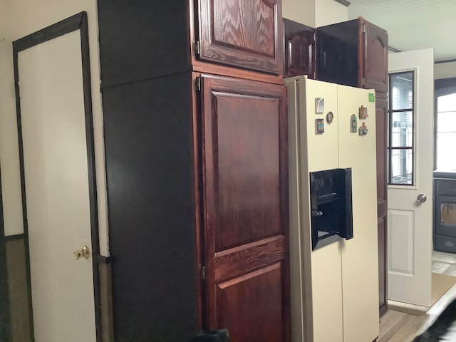 kitchen featuring white refrigerator with ice dispenser and light hardwood / wood-style flooring