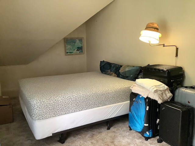 bedroom with carpet and vaulted ceiling