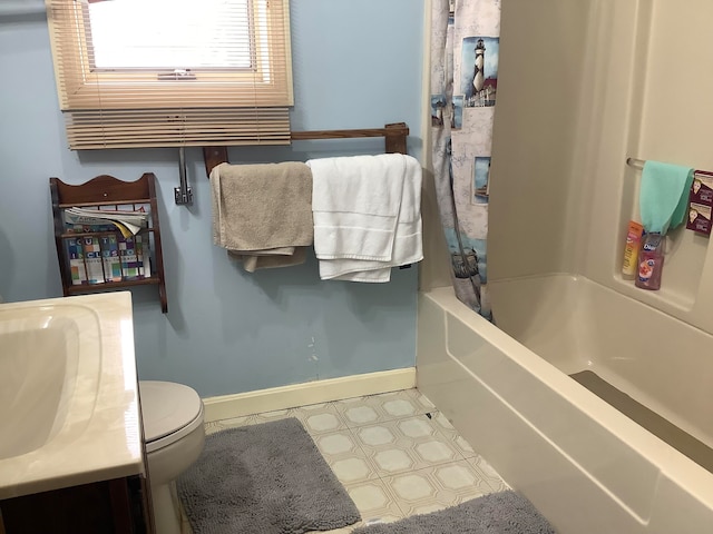 full bathroom featuring vanity, shower / tub combo, and toilet