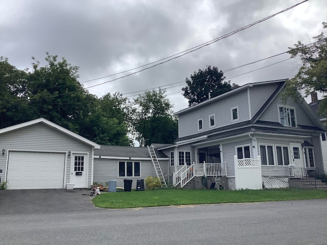 view of front of property with a porch, a garage, central air condition unit, and a front yard