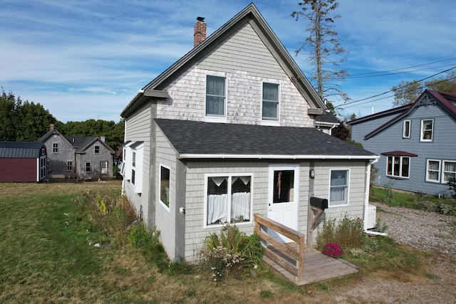 17 Pleasant St, Eastport, ME 04631 - rear view of house featuring a chimney, roof with shingles, and a yard