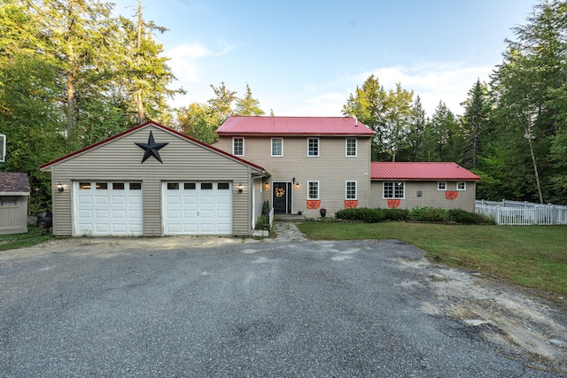 view of front facade with a front yard and a garage