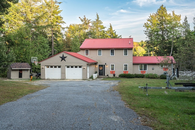 view of front of home with a storage unit, a garage, and a front lawn