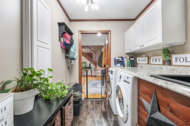 laundry area with crown molding, dark hardwood / wood-style flooring, independent washer and dryer, and cabinets