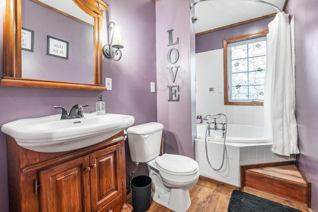 full bathroom featuring hardwood / wood-style floors, vanity, toilet, and shower / bath combo with shower curtain