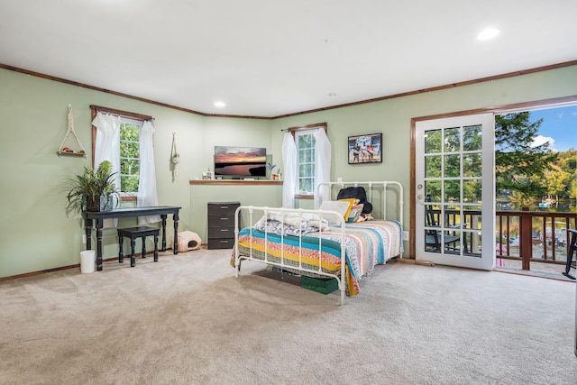 bedroom with ornamental molding, carpet floors, and access to outside