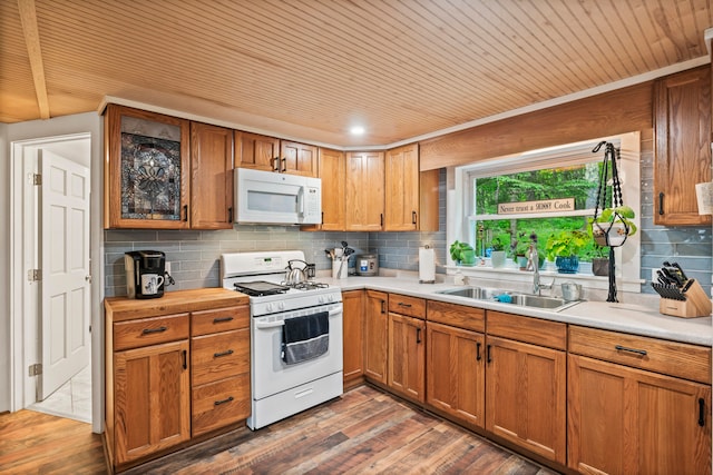 kitchen featuring backsplash, white appliances, dark hardwood / wood-style floors, and sink