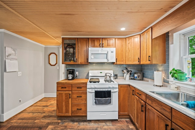 kitchen featuring white appliances, sink, tasteful backsplash, and dark hardwood / wood-style flooring