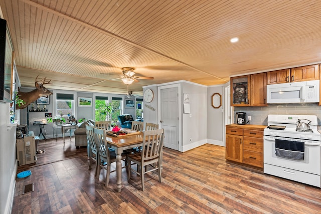 kitchen with white appliances, tasteful backsplash, ceiling fan, and hardwood / wood-style flooring