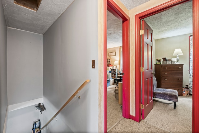 hallway featuring a textured ceiling