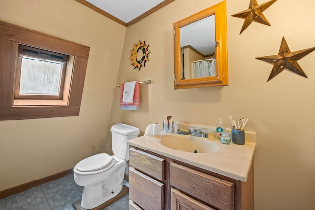 bathroom with crown molding, vanity, and toilet