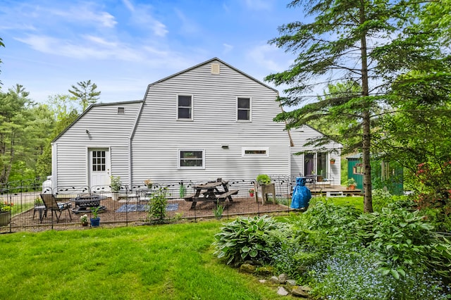 rear view of property with a lawn