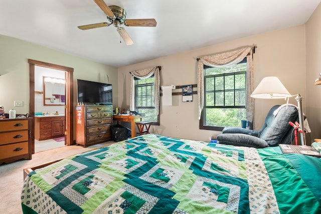 carpeted bedroom featuring connected bathroom and ceiling fan