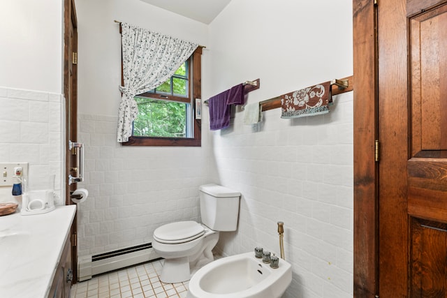 bathroom with tile walls, a baseboard heating unit, a bidet, vanity, and toilet