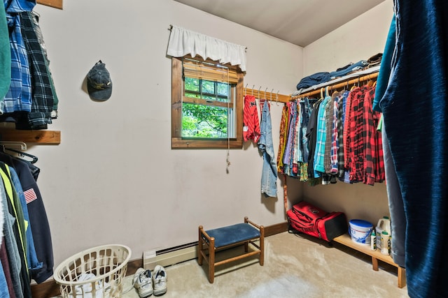 spacious closet featuring carpet and a baseboard heating unit