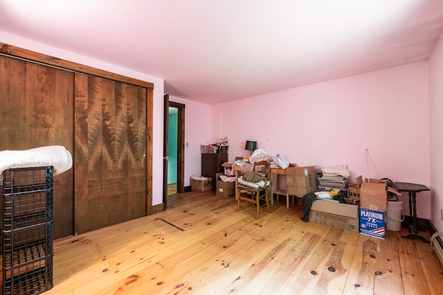 office space featuring baseboard heating and hardwood / wood-style floors