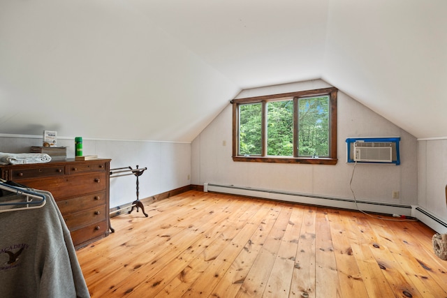 bonus room with light hardwood / wood-style floors, vaulted ceiling, baseboard heating, and a wall unit AC