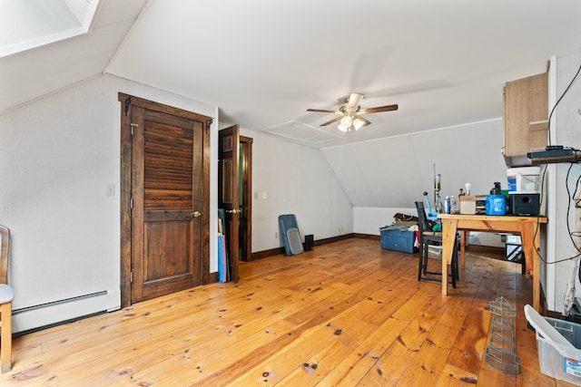 office space featuring lofted ceiling, ceiling fan, light hardwood / wood-style flooring, and a baseboard radiator