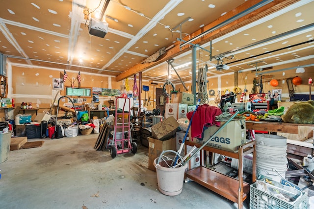 garage featuring a garage door opener and a workshop area