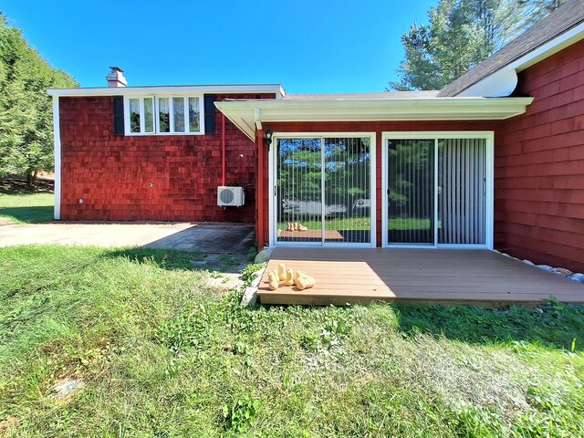 rear view of house with a lawn and a patio