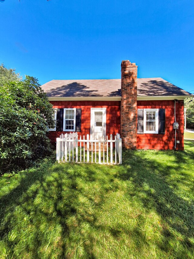 rear view of house with a yard