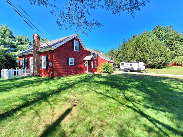 view of side of property with a yard