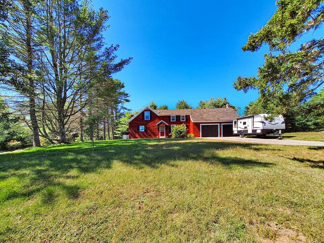 view of front of home featuring a front yard and a garage