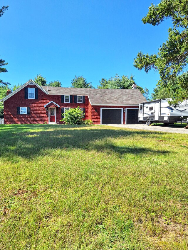 ranch-style home with a garage and a front lawn