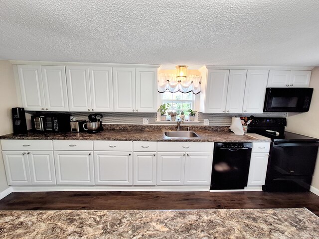 kitchen featuring sink, a textured ceiling, white cabinetry, black appliances, and dark hardwood / wood-style flooring