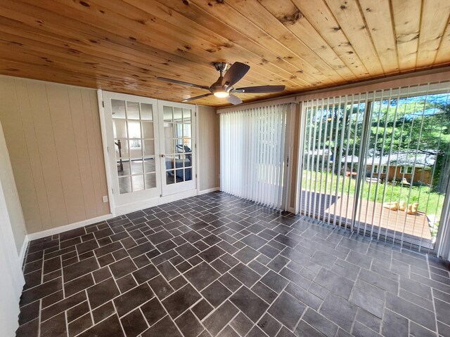 unfurnished sunroom with ceiling fan and wooden ceiling