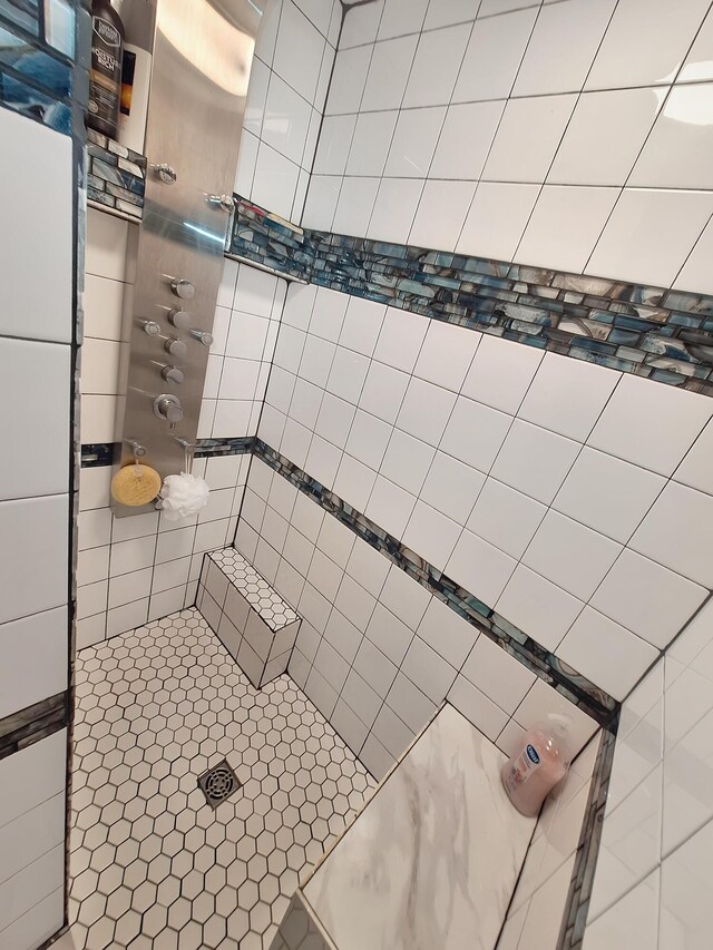 bathroom with tiled shower