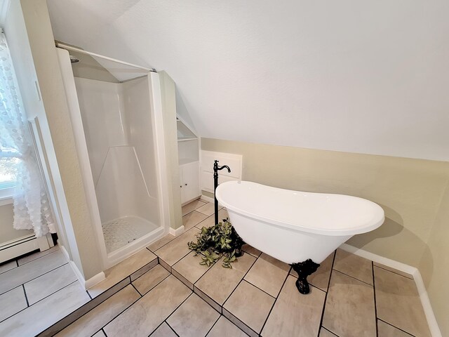 bathroom featuring plus walk in shower, vaulted ceiling, and tile patterned floors