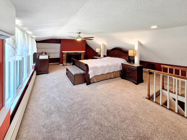 bedroom with ceiling fan, a textured ceiling, light carpet, a fireplace, and vaulted ceiling