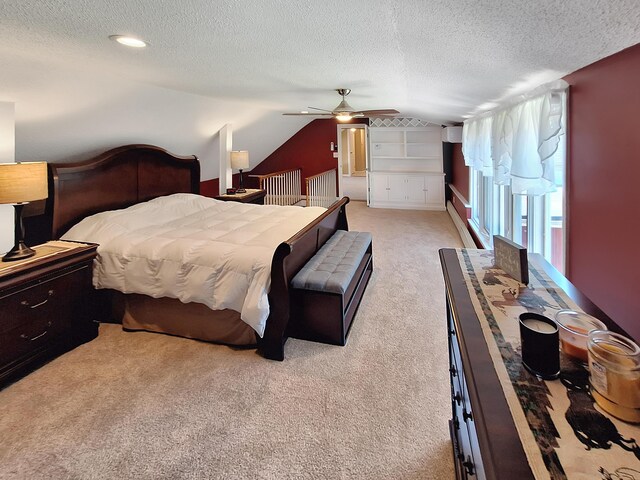 carpeted bedroom featuring ceiling fan, a textured ceiling, and vaulted ceiling