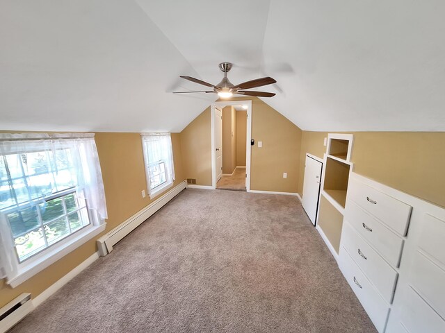 bonus room with light carpet, lofted ceiling, ceiling fan, and baseboard heating