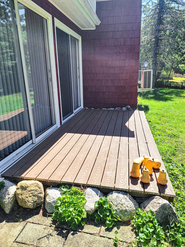 wooden terrace with a lawn