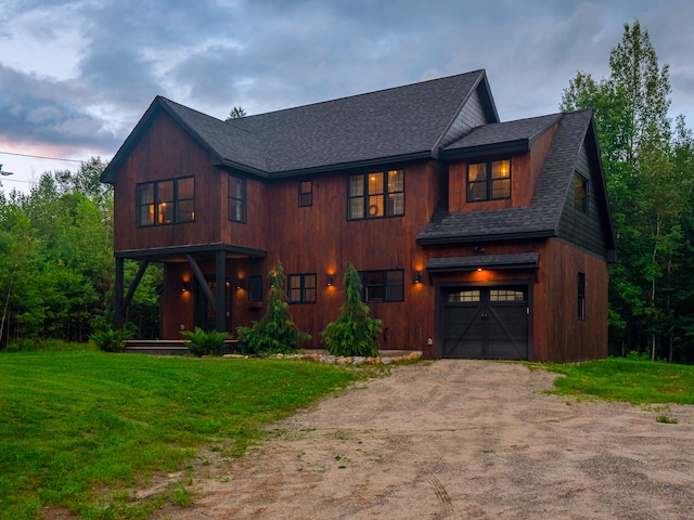 view of front facade featuring a lawn and a garage