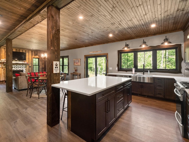 kitchen featuring a center island, wooden ceiling, a fireplace, and sink