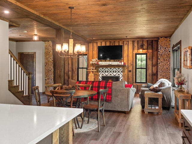 dining room featuring wood-type flooring, a chandelier, and wooden ceiling