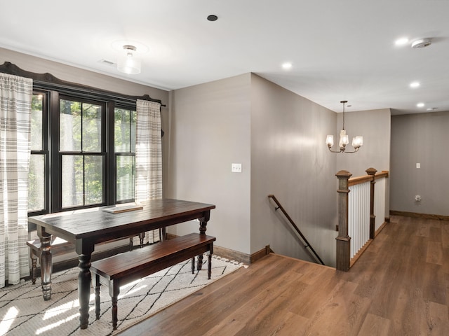 dining area featuring an inviting chandelier and dark hardwood / wood-style floors