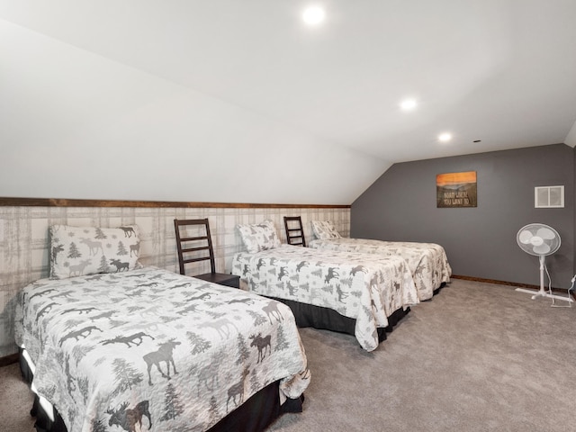 bedroom with carpet floors and lofted ceiling