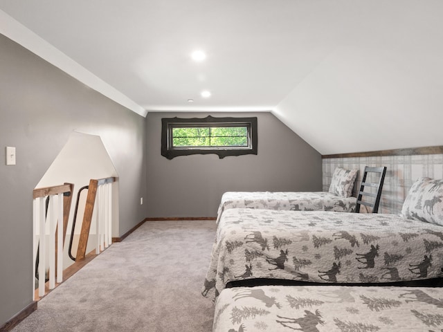 carpeted bedroom with lofted ceiling