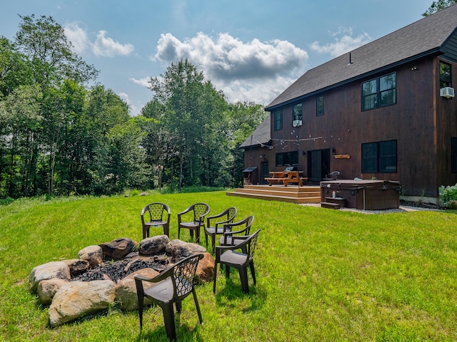 view of yard with a wooden deck and a fire pit